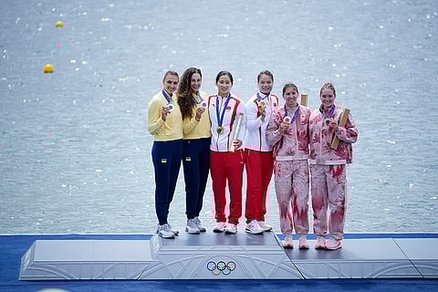 Paris Olympics women's canoe double 500-meter: Silver medalists Ukraine's Liudmyla Luzan and Anastasiia Rybachok, from left, gold medalists China's Sun Mengya and Xu Shixiao and bronze medalists Canada's Sloan MacKenzie and Katie Vincent